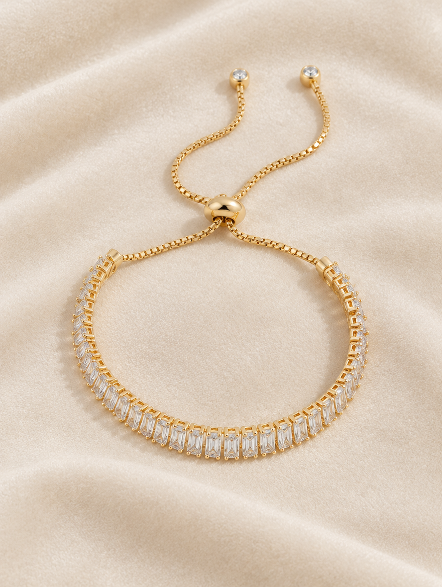 Gold baguette tennis bracelet on cream velvet