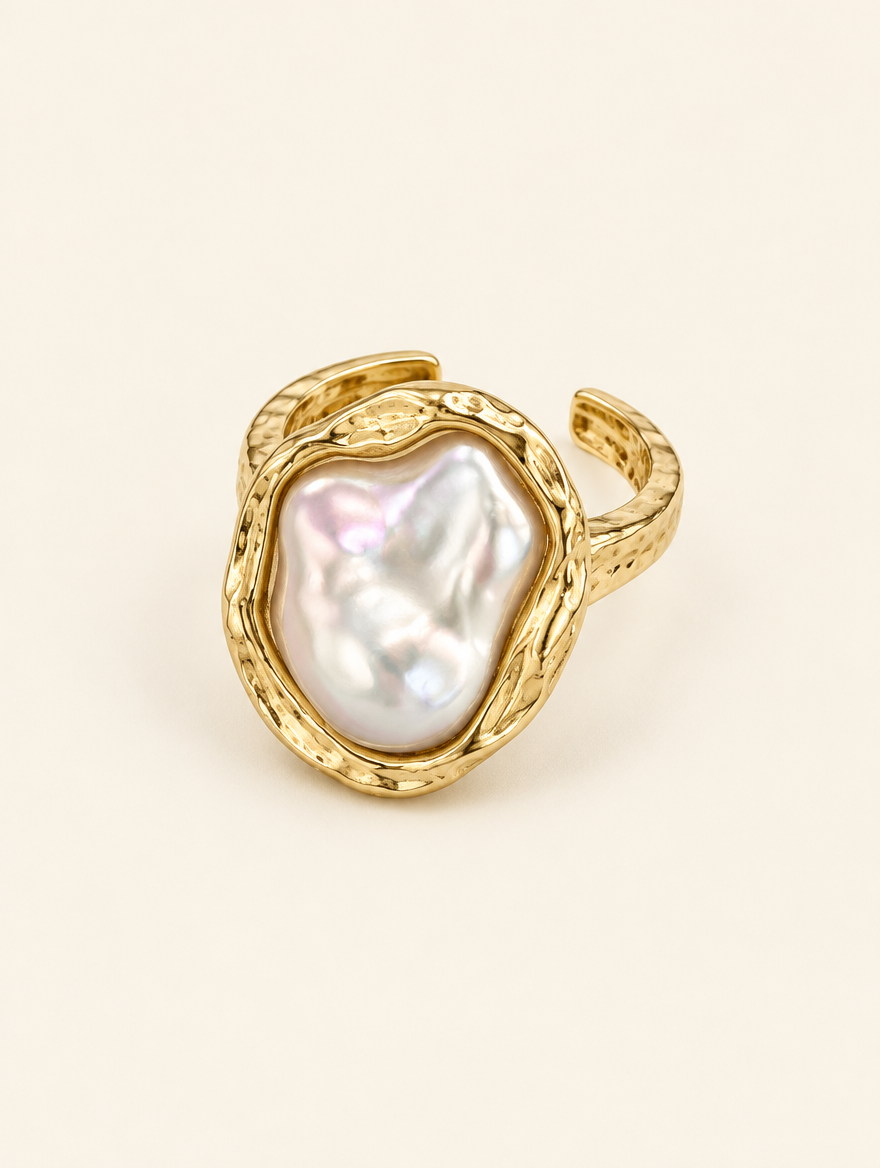 Gold textured baroque pearl ring on a neutral background