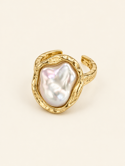 Gold textured baroque pearl ring on a neutral background