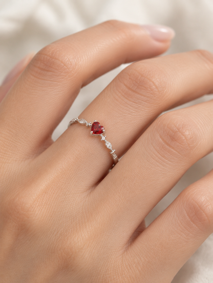 Woman wearing a silver red heart crystal ring on her finger