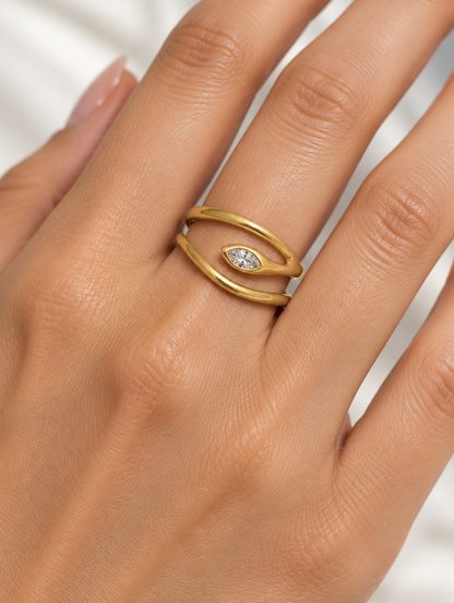 Woman wearing a gold snake head zirconia ring on her finger