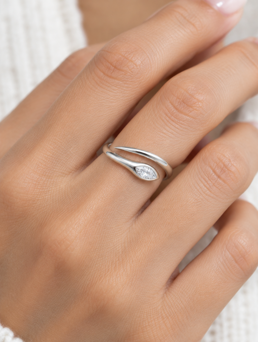 Woman wearing a silver snake head zirconia ring on her finger