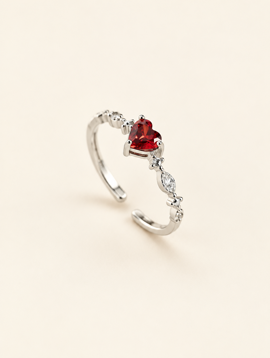 Silver red heart crystal ring on a neutral background