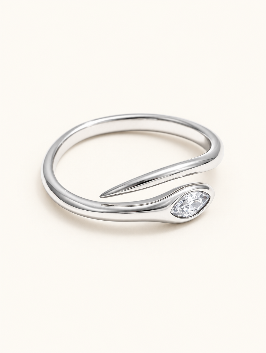 Silver snake head zirconia ring on a neutral background
