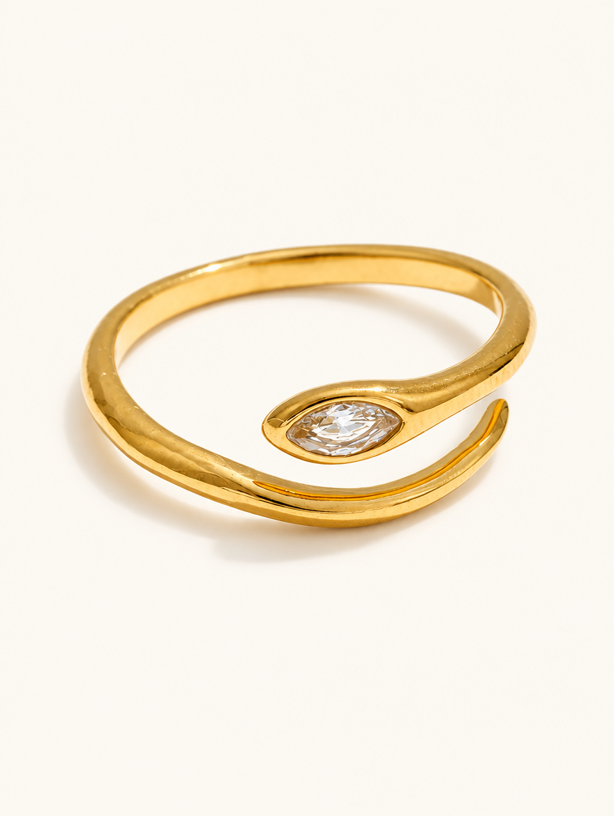 Gold snake head zirconia ring on a neutral background