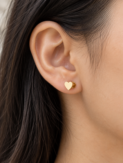 Woman wearing a gold heart stud earring
