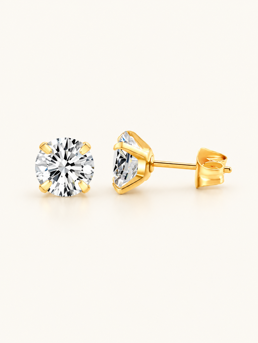 Pair of gold claw-set cz stud earrings on a warm off-white background