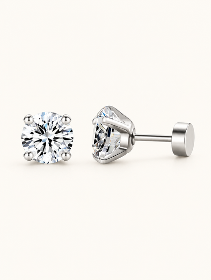 Pair of silver claw-set cz stud earrings on a warm off-white background