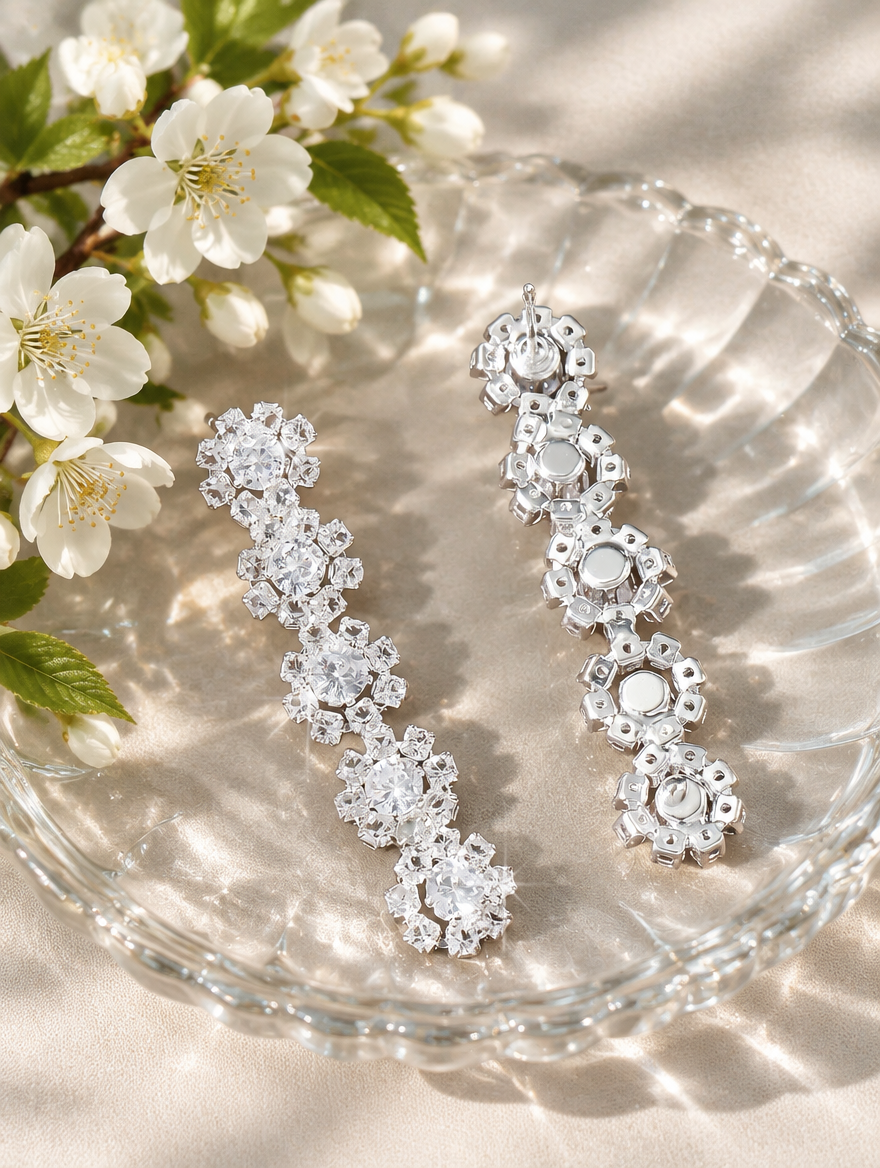 Silver floral crystal long drop earrings in a styled still life with props