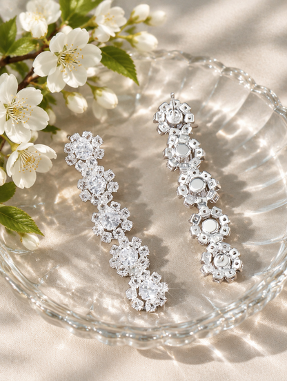 Silver floral crystal long drop earrings in a styled still life with props