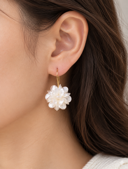 Woman wearing a pearl-look petal ball hook earring
