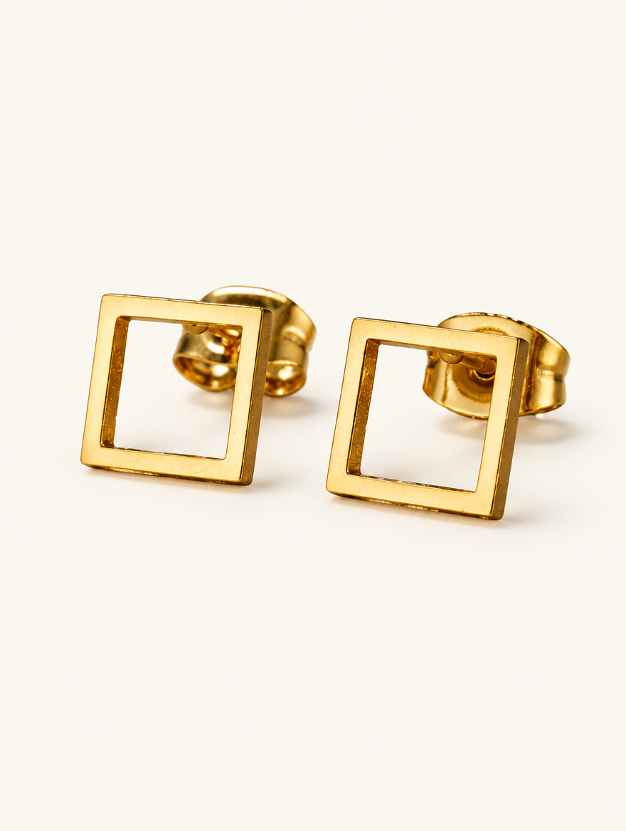 Pair of gold open square stud earrings on a warm off-white background