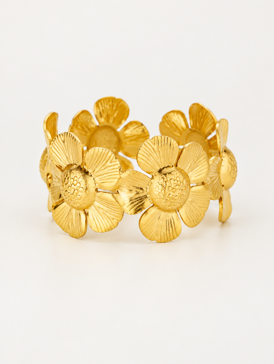 Gold daisy flower band bracelet on a neutral background