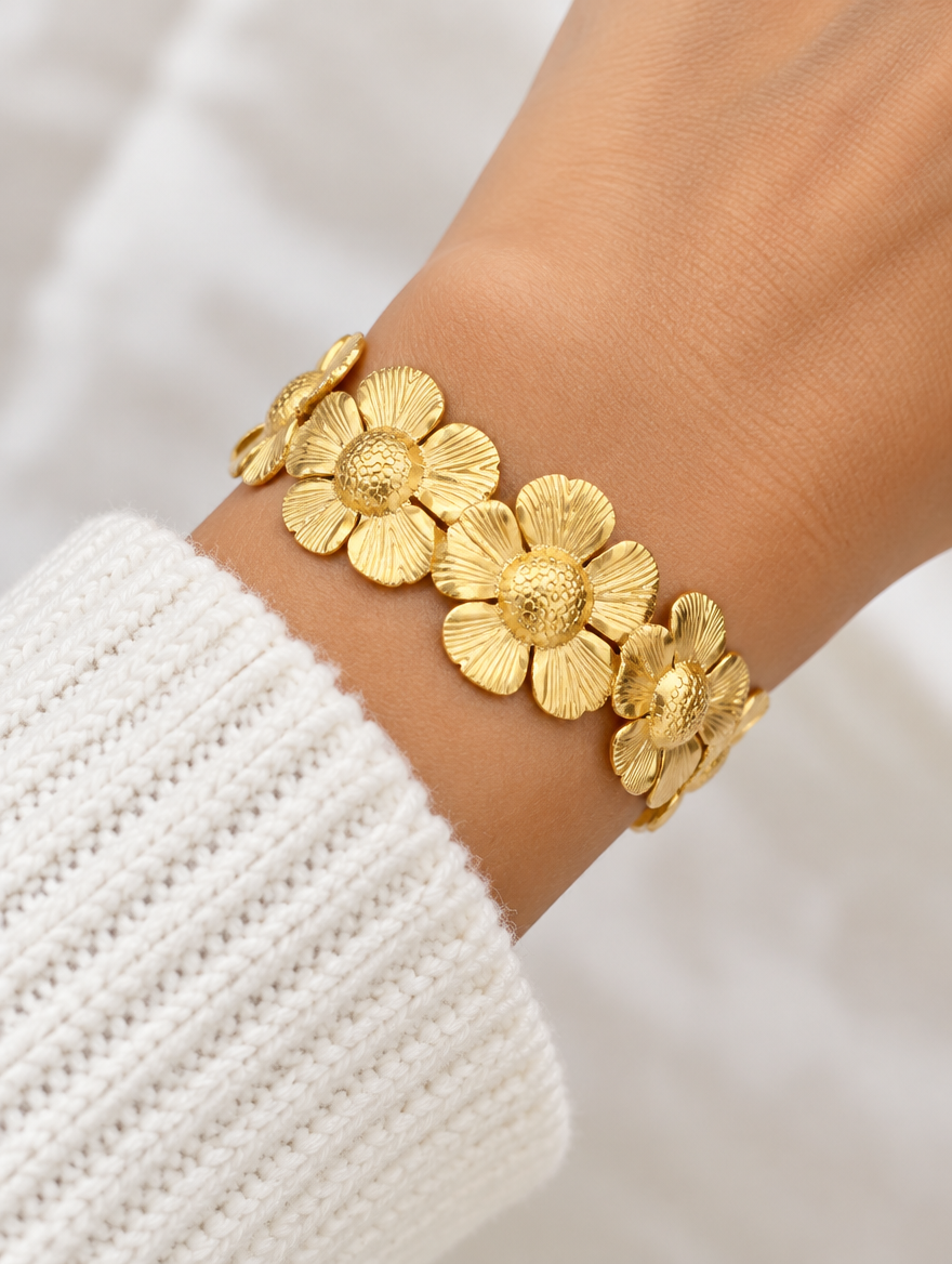 Woman wearing a gold daisy flower band bracelet