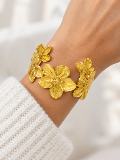 Woman wearing a gold flower open cuff bracelet