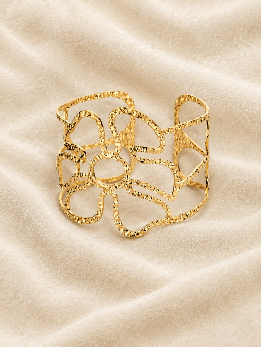 Gold wavy openwork cuff on cream velvet