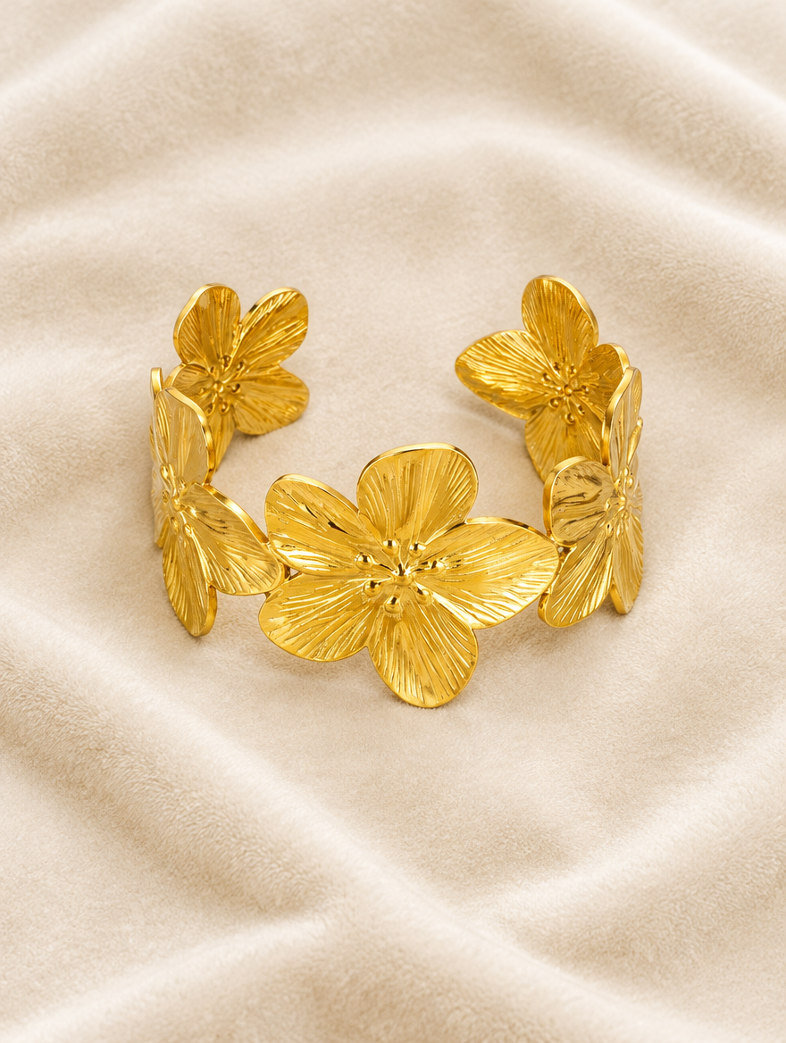 Gold flower cuff bracelet on cream velvet
