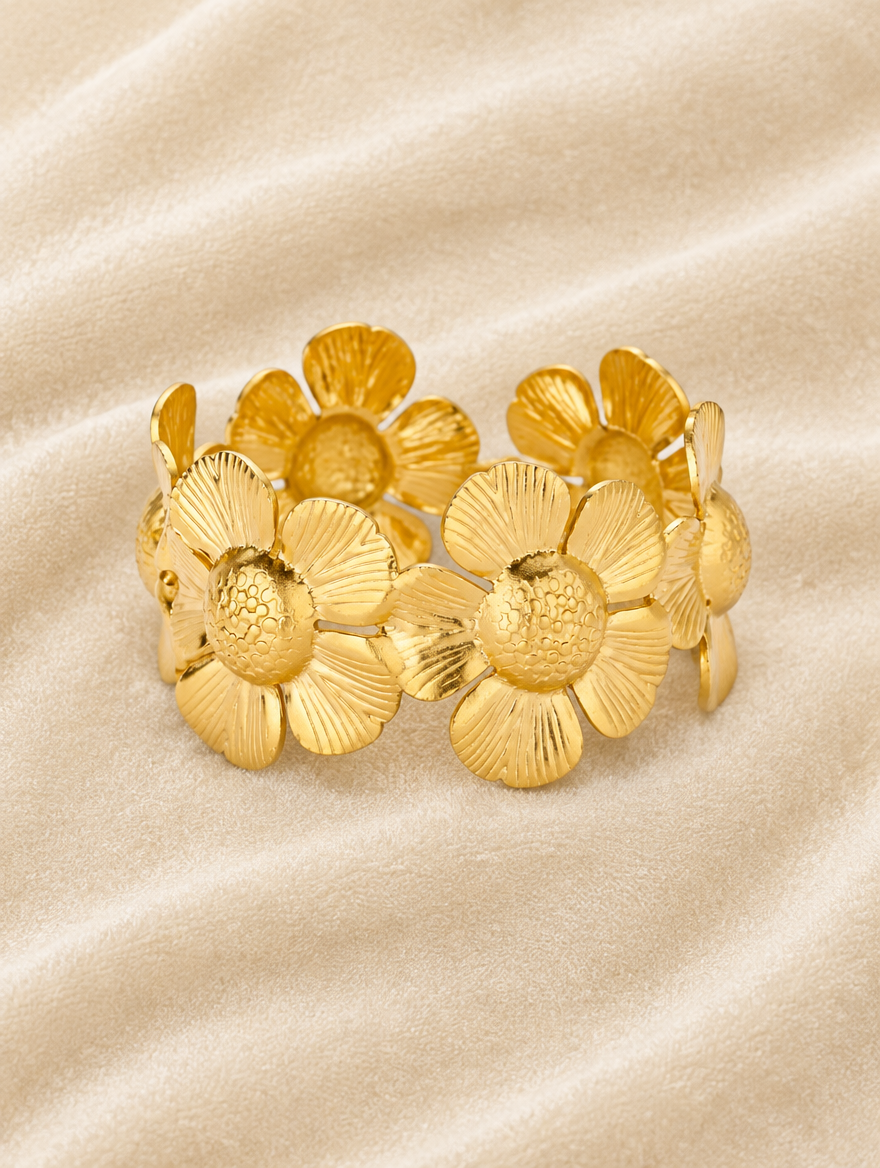 Gold daisy band bracelet on cream velvet