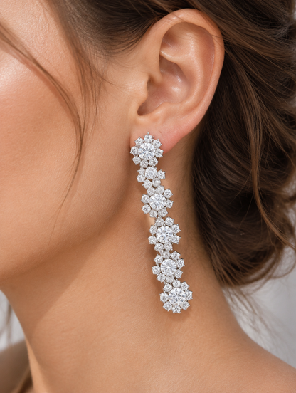 Woman wearing a silver floral crystal long drop earring
