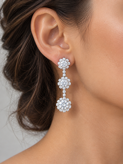 Woman wearing a silver three-flower crystal drop earring