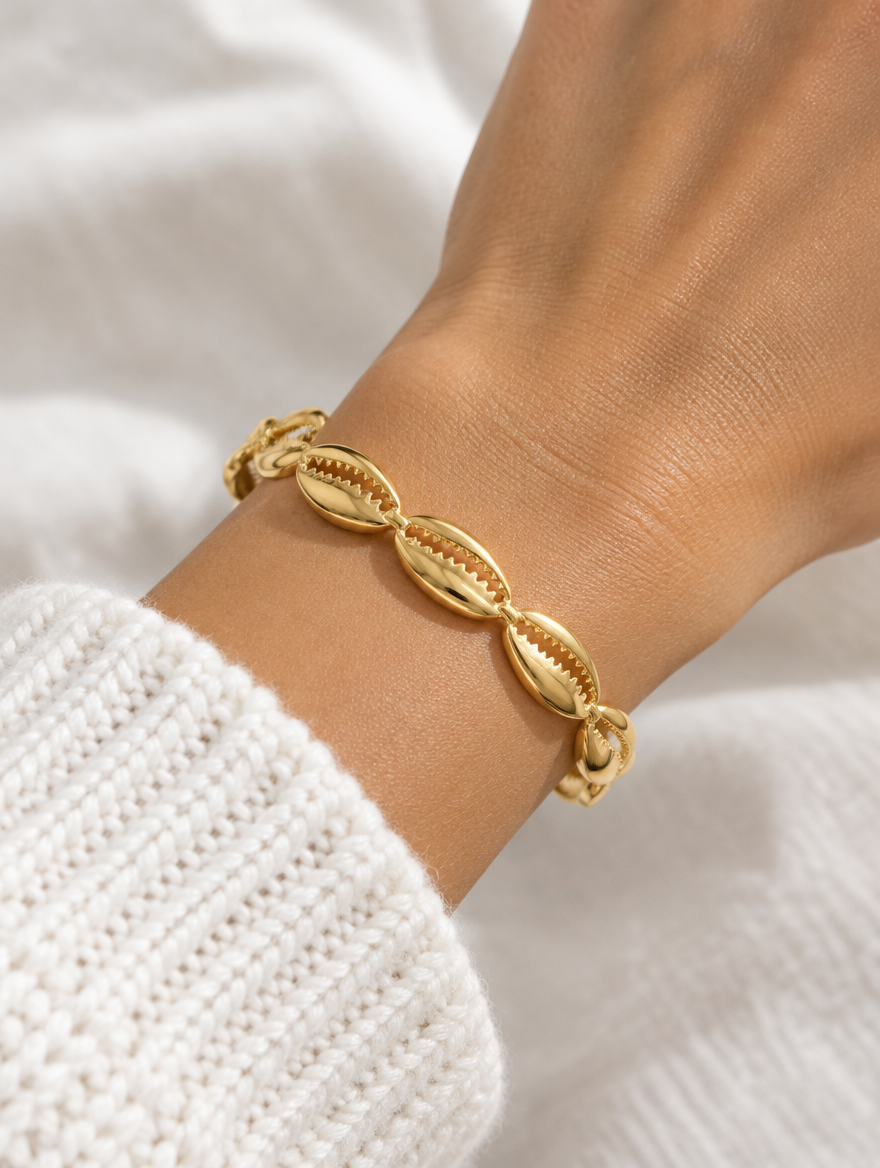 Woman wearing a gold hollow shell open cuff bracelet