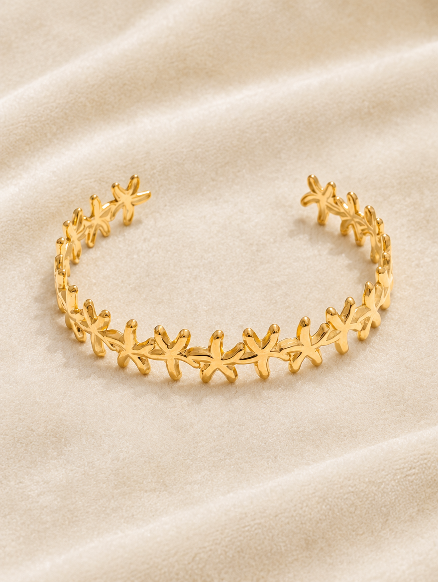 Gold starfish cuff bracelet on cream velvet