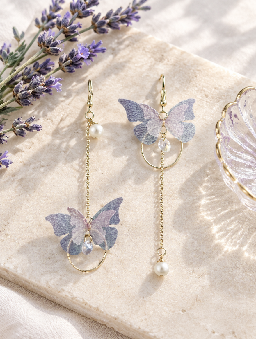 Lilac butterfly chain drop earrings in a styled still life with props
