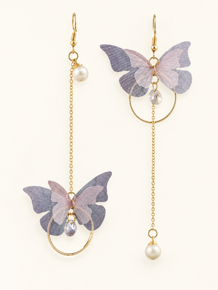 Pair of lilac butterfly chain drop earrings on a warm off-white background