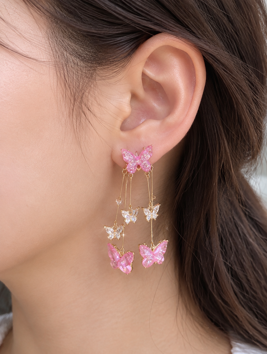 Woman wearing a pink butterfly tassel drop earring