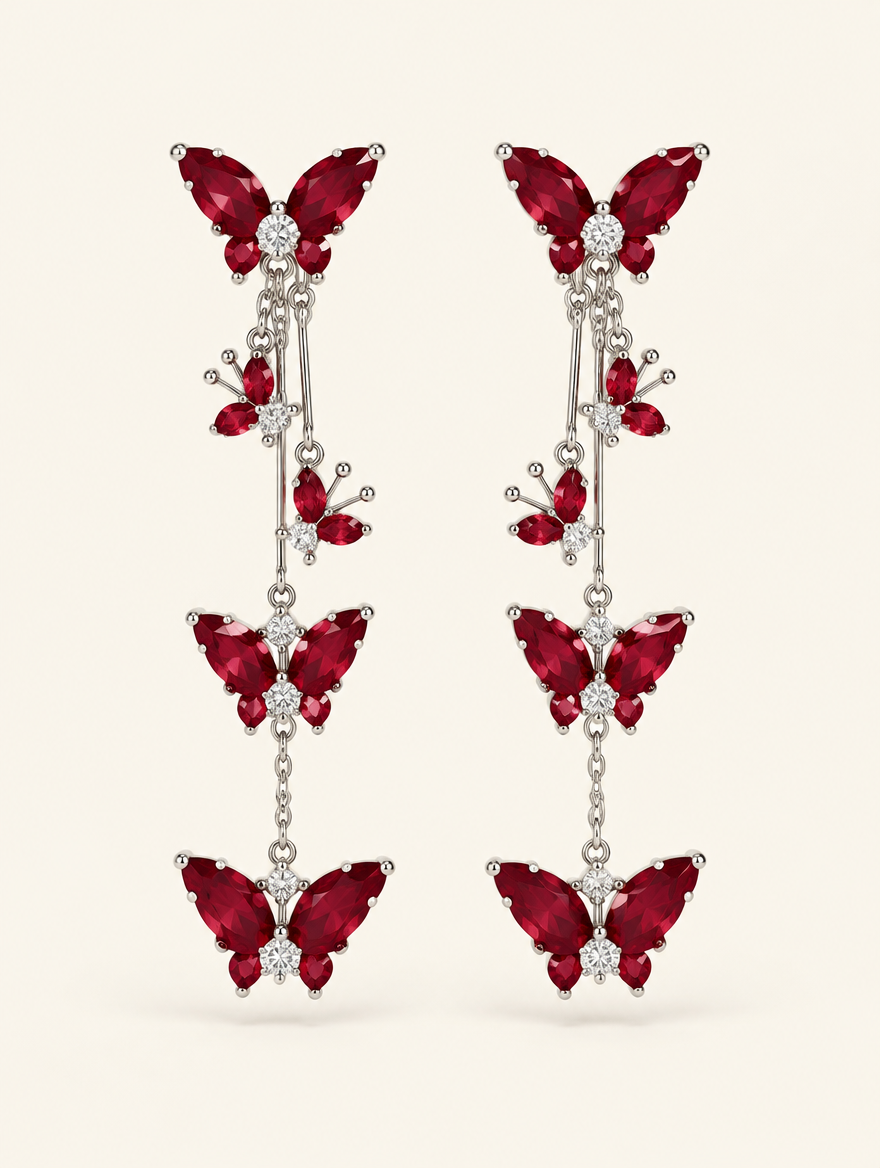 Pair of red butterfly tassel drop earrings on a warm off-white background