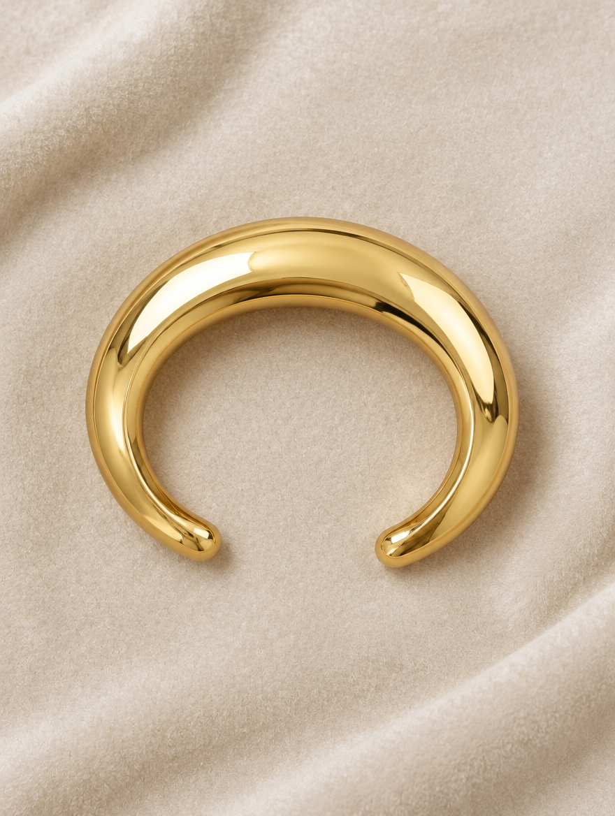 Chunky gold-tone bangle on cream velvet