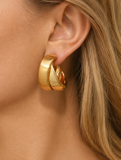 Woman wearing a chunky gold hoop earring