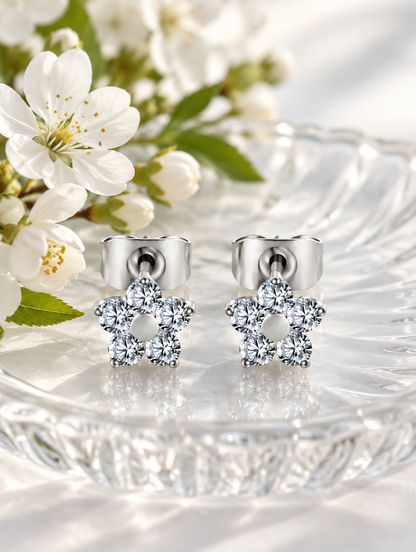Titanium CZ flower stud earrings in a styled still life with props