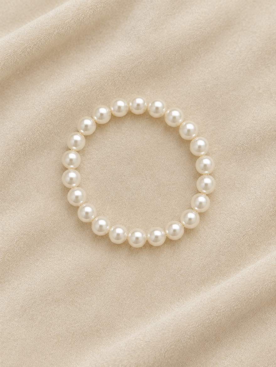 White faux pearl bracelet on cream velvet