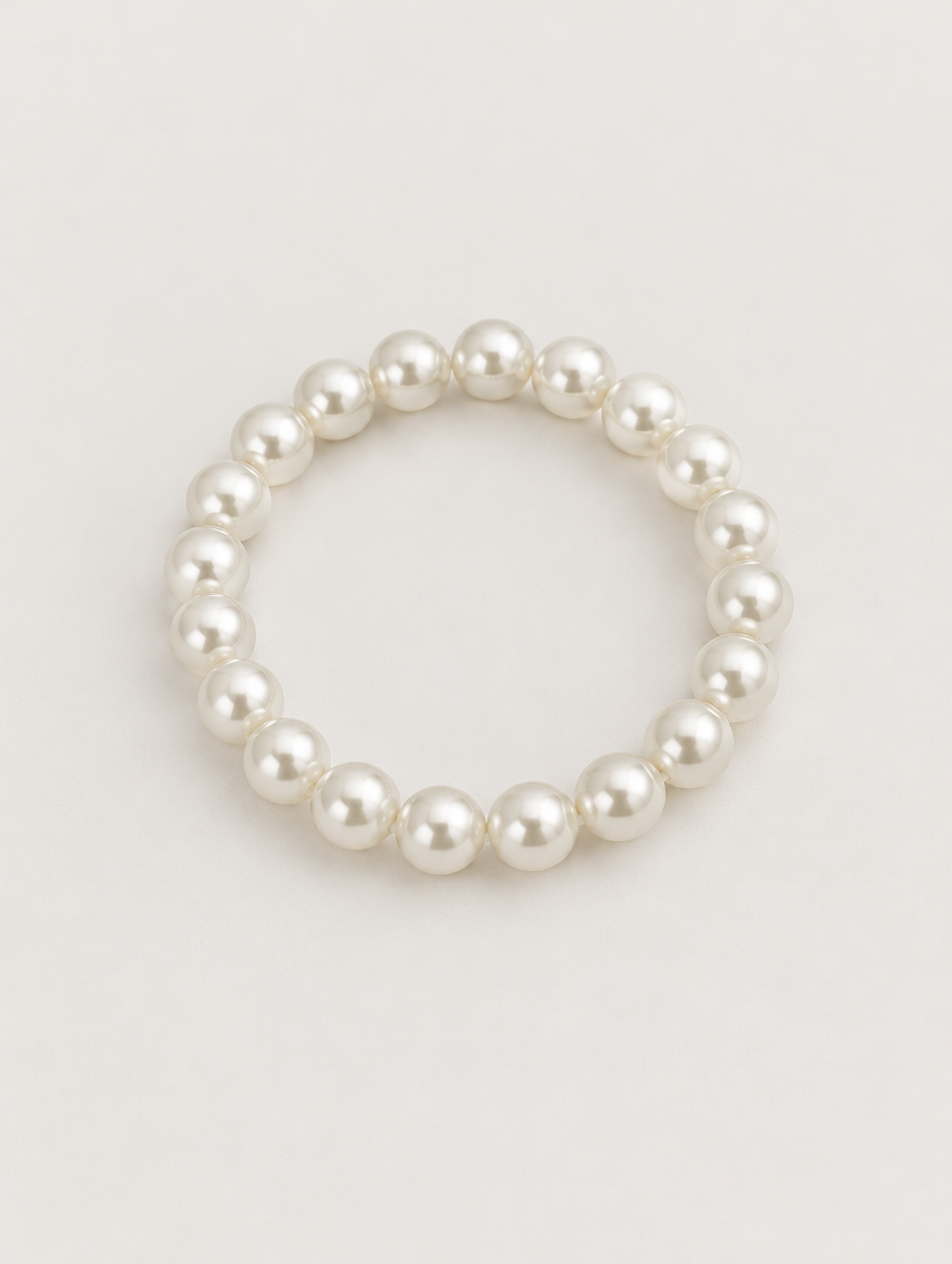 White faux pearl beaded bracelet on a neutral background