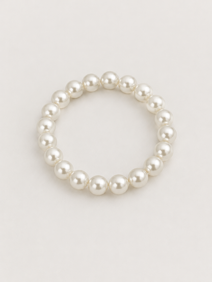 White faux pearl beaded bracelet on a neutral background
