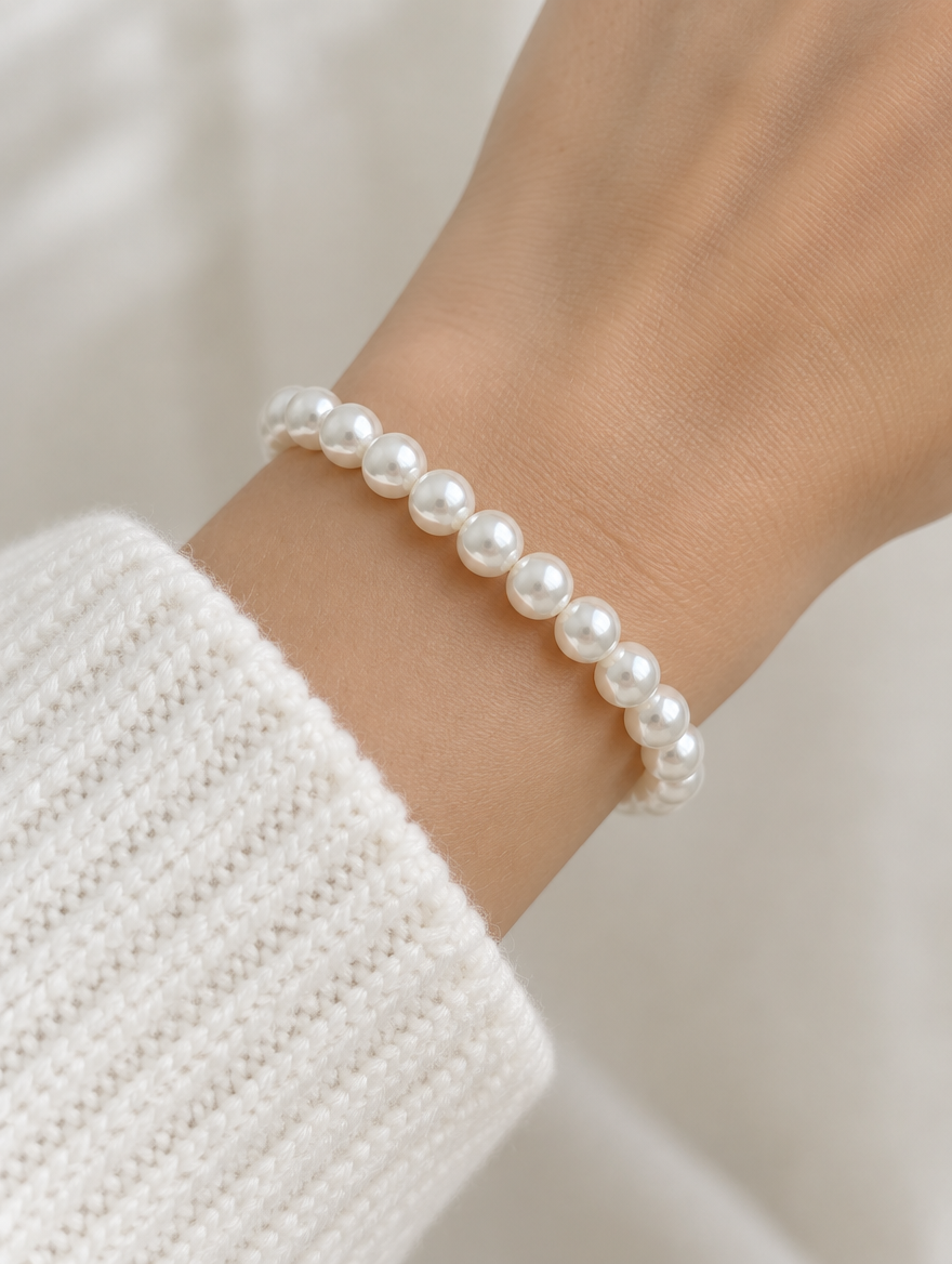 Woman wearing a white faux pearl beaded bracelet