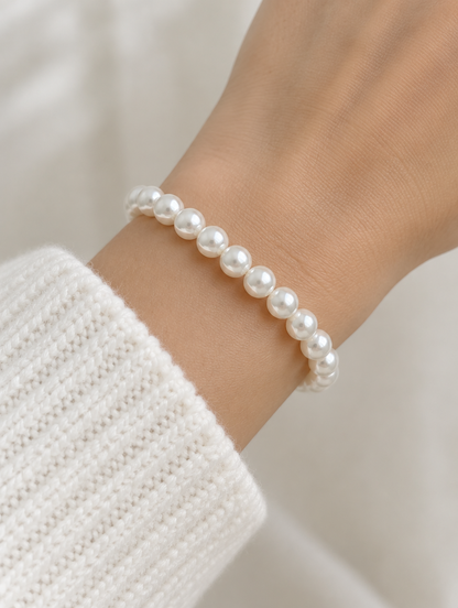 Woman wearing a white faux pearl beaded bracelet