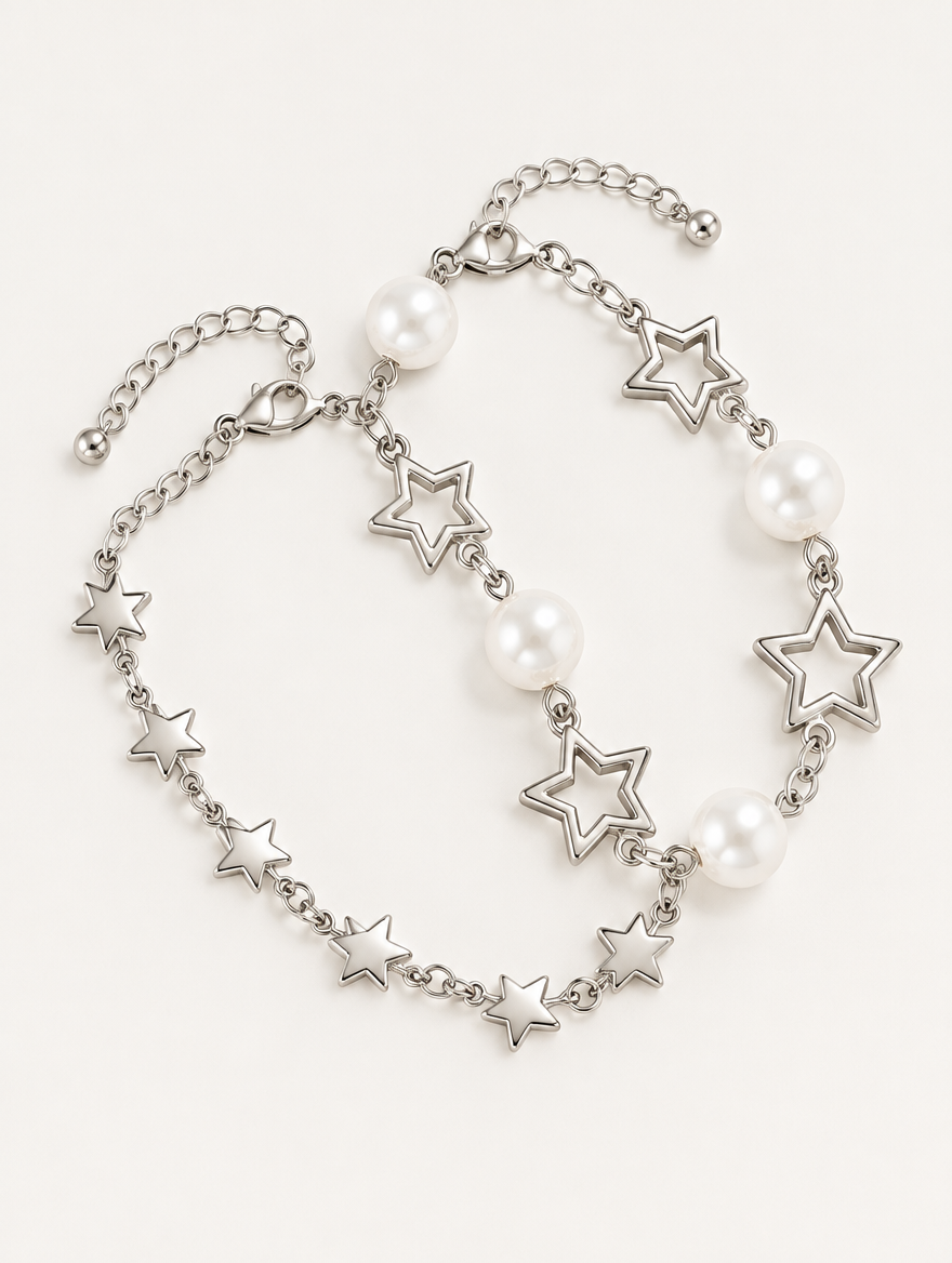 Silver-tone star chain bracelet set with faux pearls on a neutral background
