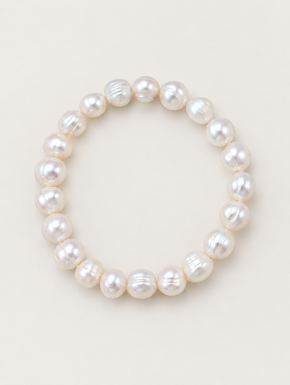 White freshwater baroque pearl bracelet on a neutral background