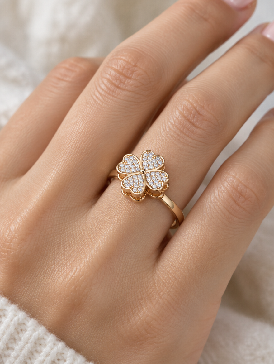 Woman wearing a gold four leaf clover zirconia ring on her finger