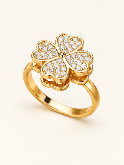 Gold four leaf clover zirconia ring on a neutral background