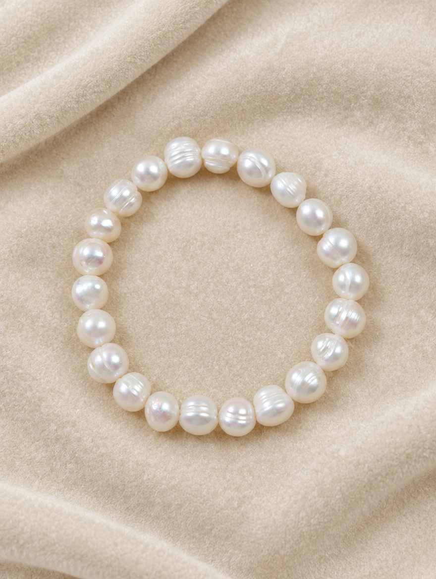 White pearl bracelet on cream velvet