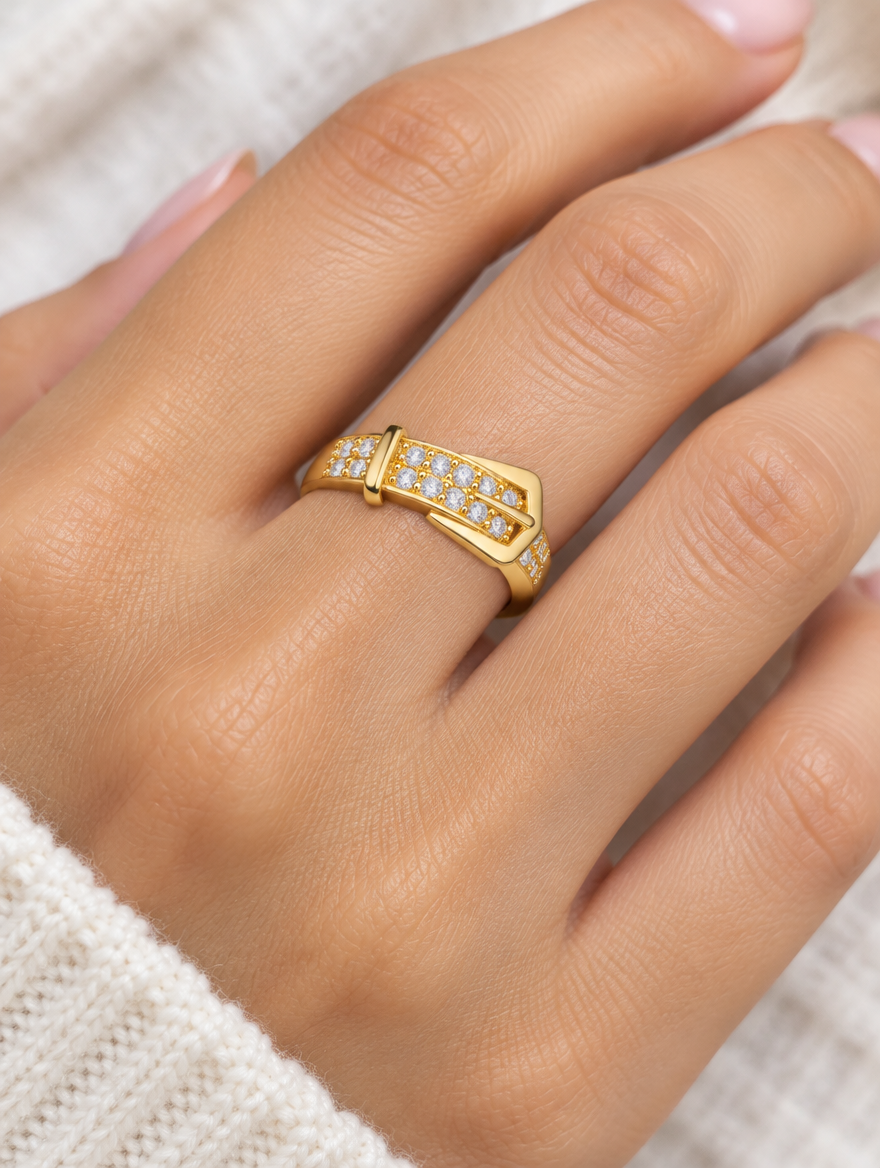 Woman wearing a gold belt buckle zirconia ring on her finger