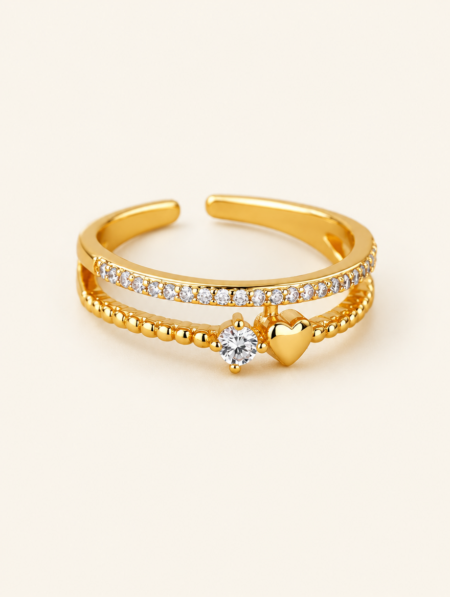 Gold double band heart zirconia ring on a neutral background