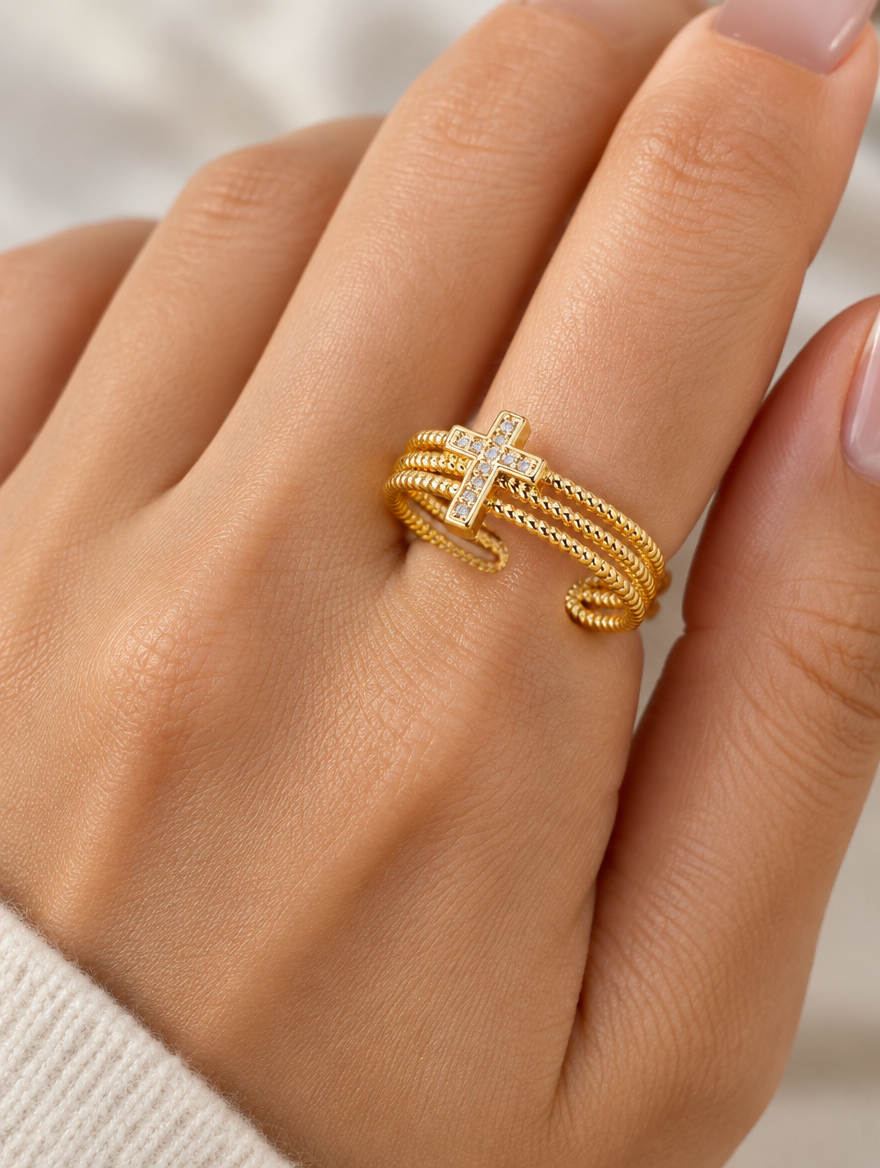 Woman wearing a gold ribbed triple band cross zirconia ring on her finger