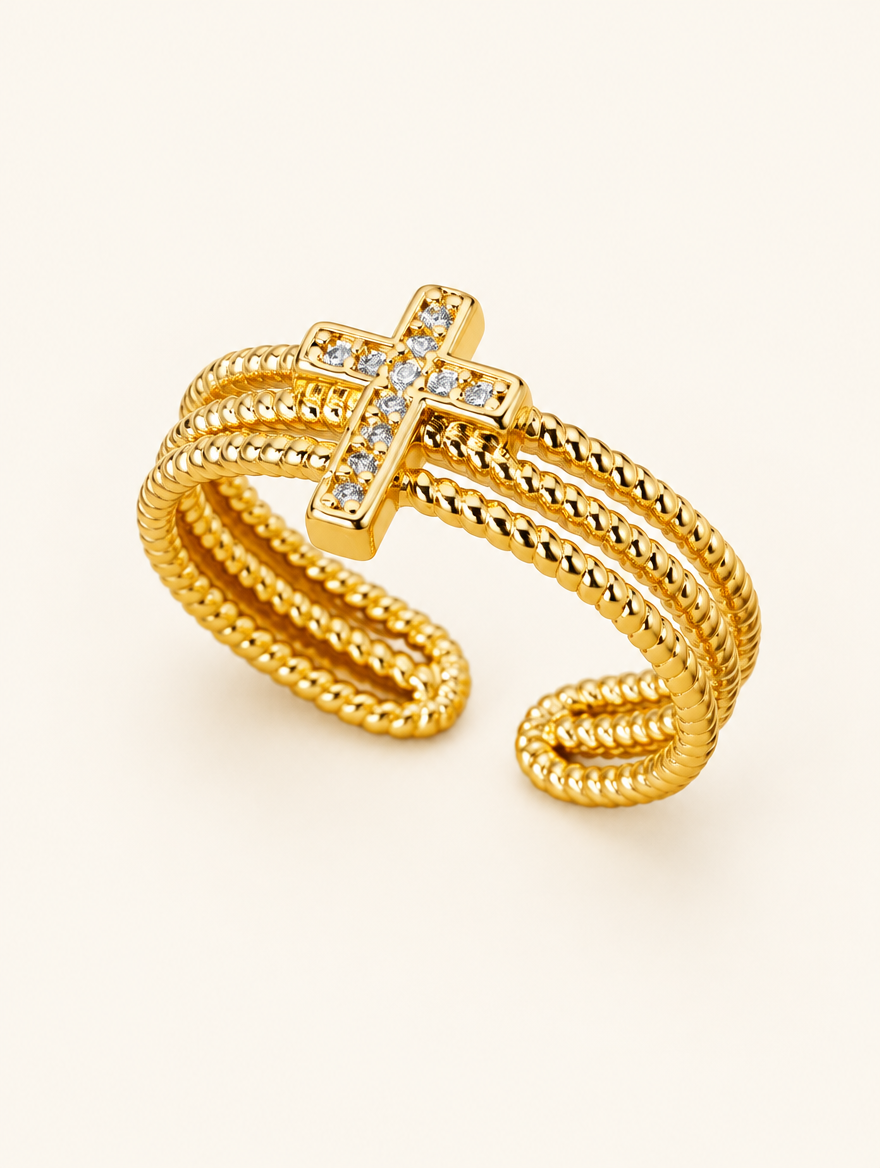 Gold ribbed triple band cross zirconia ring on a neutral background
