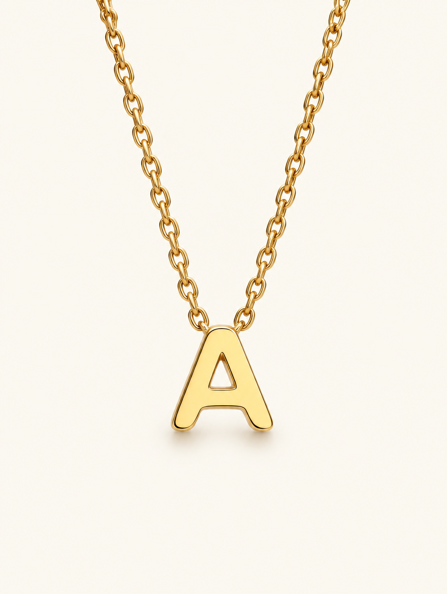 Gold initial letter A pendant necklace on a neutral background