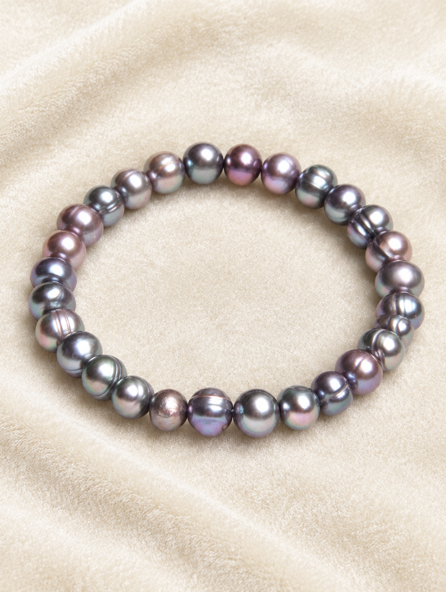 Black freshwater pearl stretch bracelet on cream velvet