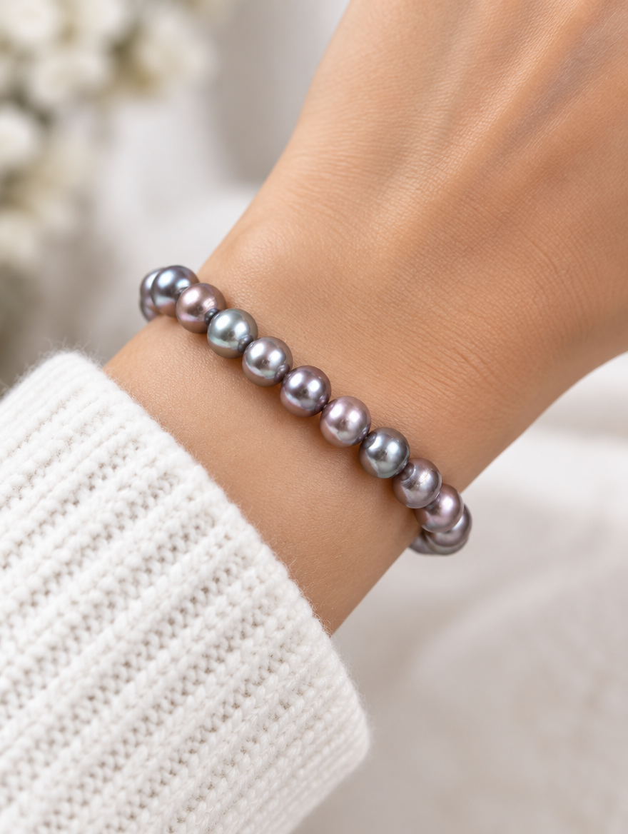 Black freshwater pearl stretch bracelet worn on a wrist